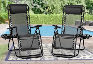 two black zero gravity chairs by a pool