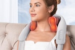 a woman wearing a neck massager