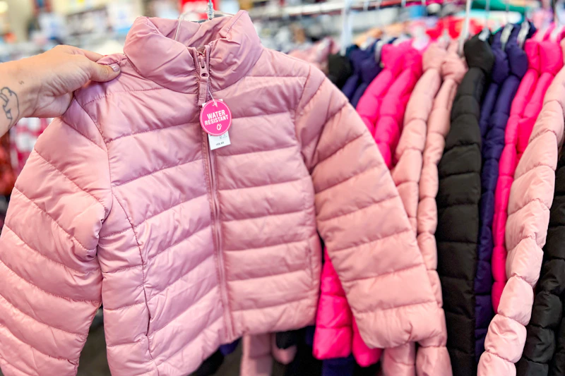 Hand holding kids coat