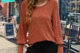 a woman wearing a long sleeve top