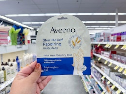 hand holding aveeno hand mask in walgreens