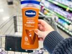 hand holding a bottle of vaseline lotion