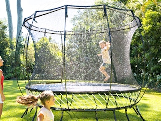 kids jumping on a sprinkler
