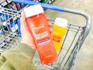 2 Suave Exfoliating Body Washes (one held up over Walmart shopping cart/one in cart)