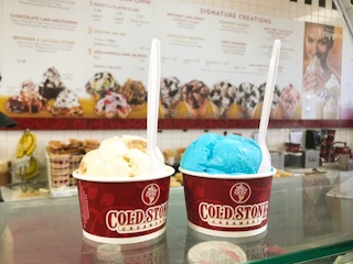 Two cups of small ice cream at Cold Stone Creamery on the counter.