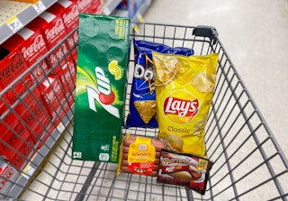 walgreens cart filled with food, lays chips, doritos, oscar mayer hot dogs, ball park franks, and 7up soda