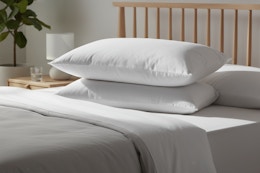 linens & hutch pillows on a bedd