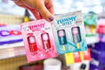 hand holding cover girl yummy bites mini gloss kits