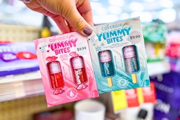 hand holding cover girl yummy bites mini gloss kits