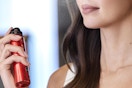 a woman using l'oreal setting spray