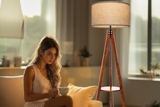 a woman near a floor lamp