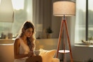 a woman near a floor lamp