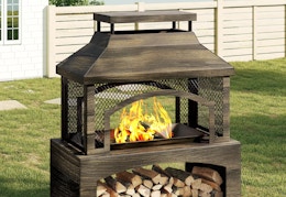 large freestanding fire pit with log storage