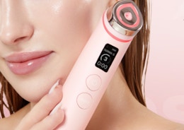 a person holding a pink Medicube Booster Pro