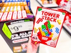 hand holding a tower stack game in front of target signage
