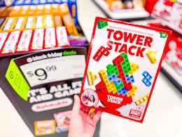 hand holding a tower stack game in front of target display