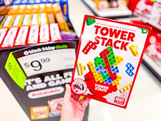 hand holding a tower stack game in front of target display