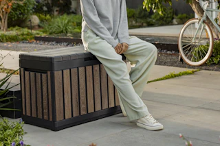 woman sitting on deck box