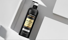 a black and gold bottle of conditioner