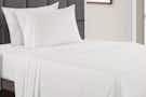 white cooling sheets on a bed