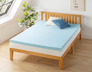 a blue memory foam mattress on a bed in a room