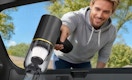 a person vacuuming the inside of a car
