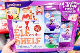 hand holding elf on the shelf activity kit