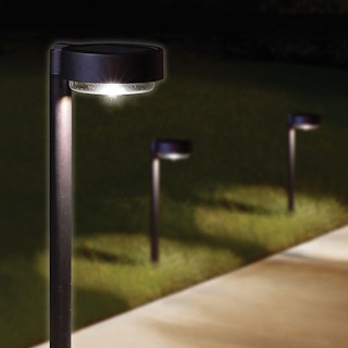 black led solar pathway lights on the edge of a sidewalk