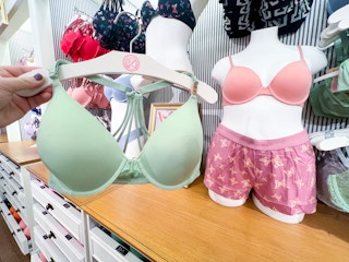 someone holding a wear everywhere bra from pink