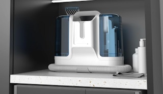 a portable carpet cleaner on a shelf