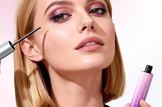 a woman applying serum