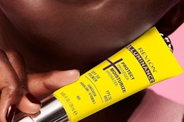 a woman holding a revlon primer