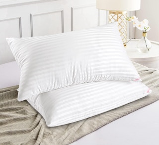 two pillows stacked on a bed