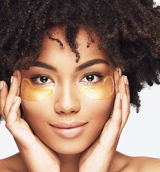 a woman with under eye masks on