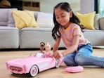 a child playing with a Barbie corvette
