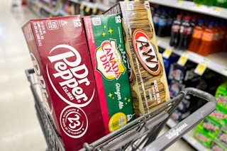 angled view of shopping cart with packs of soda