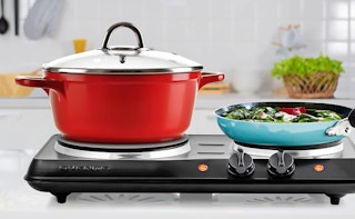 two colorful pots on a portable electric double burner