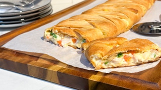 a chicken braided crescent roll meal on a cutting board