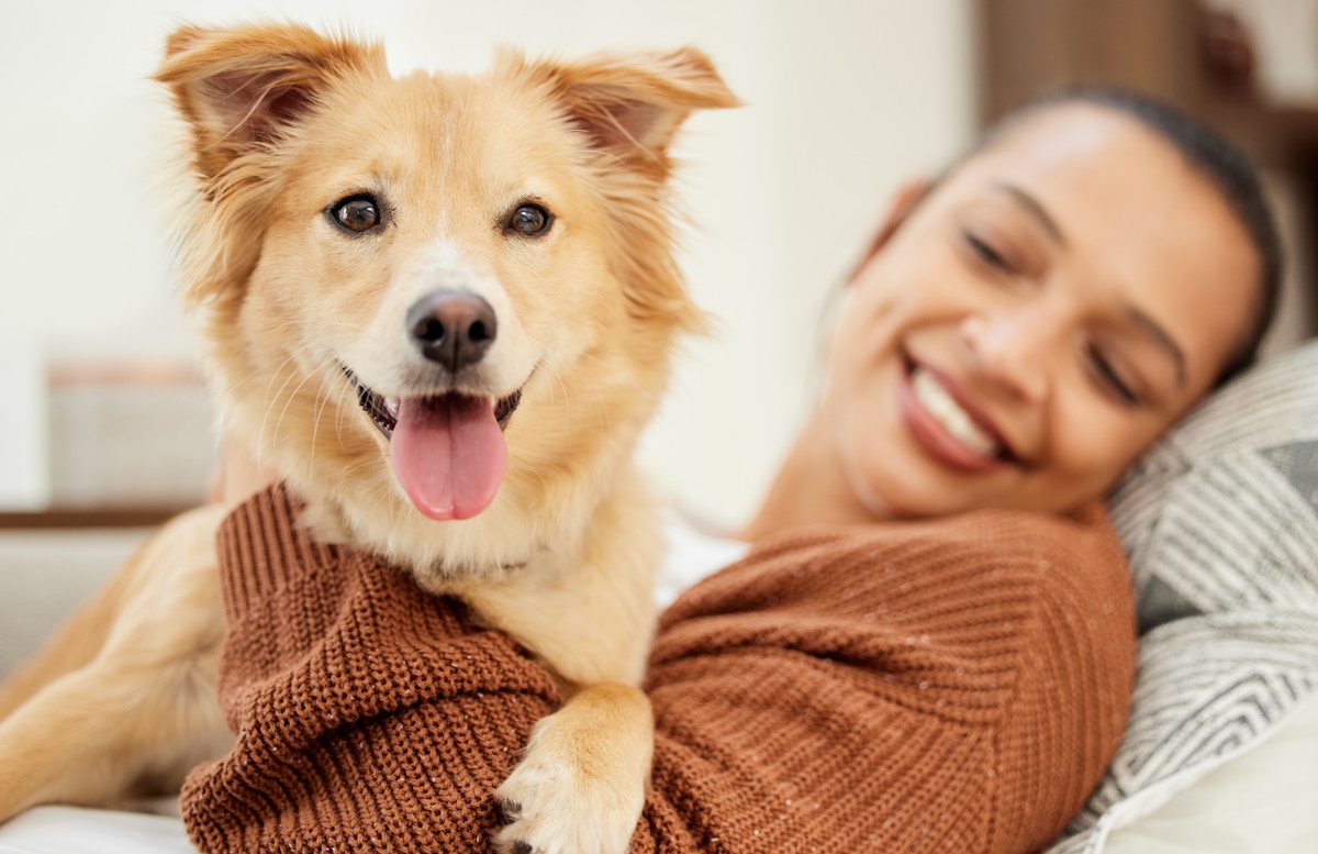 Women playing with dog