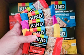 hand holding a variety of kind bars