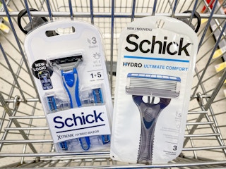 A couple of Schick razors sitting in a store cart.