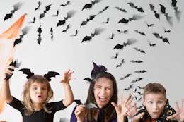 a family in front of bat wall decorations