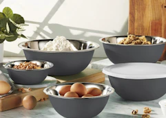 grey mixing bowls on a counter with baking ingrdients inside