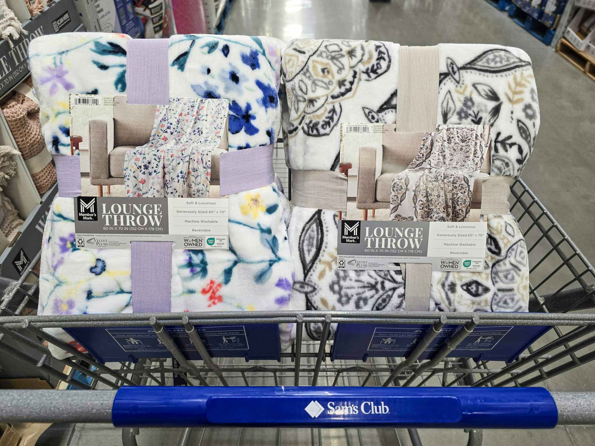 2 printed throw blankets in a cart