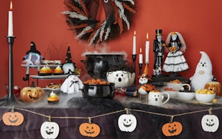 halloween tablescape of candy bowls and mugs