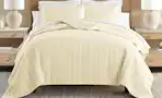 Lifestyle image of a quilted comforter set in yellow (lifestyle image)