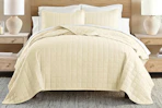 Lifestyle image of a quilted comforter set in yellow (lifestyle image)