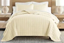 Lifestyle image of a quilted comforter set in yellow (lifestyle image)
