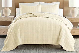 Lifestyle image of a quilted comforter set in yellow (lifestyle image)