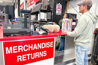 a person standing in front of return counter in costco